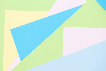 Blue, pink, green pastel color paper geometric flat lay background. Copy space.