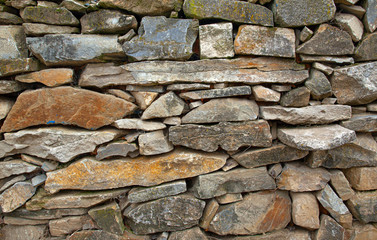 Stone wall dry construction photo wall without mortar
