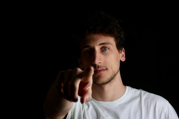 serious guy indicating on camera with finger