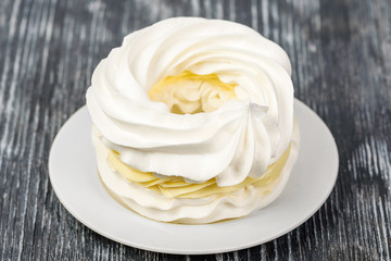 Meringue with lemon cream on a white napkin