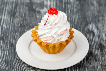 cake basket with meringue and cherry jam and cocktail cherries