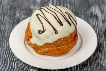 Cake brewed with cream of condensed milk with sugar and white chocolate glaze. Russian Sweeten cake