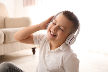 Little boy listening to music at home