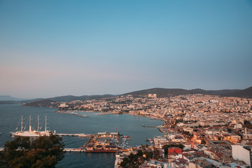 Kusadasi, Aydin Province, Turkey. Waterfront And Kusadasi Cityscape In Summer Evening. Scenic View Of Kusadasi Skyline At Aegean Coast, Turkey