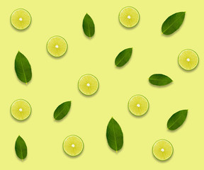 Creative background made of summer tropical fruits with leaves, grapefruit, orange, tangerine, lemon, lime on pastel yellow background. Food concept. Flat lay, top view, copy space