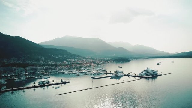 Top view on the marina with yachts and the city surrounded the amazing mountscape