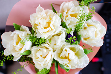 bouquet of white tulips packed in a pink envelope