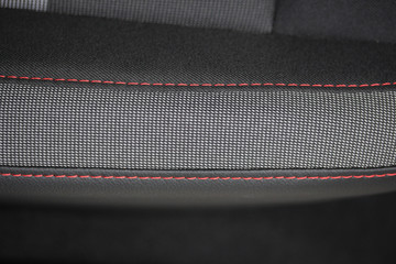 Red and grey fabric with red stitching 
