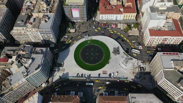 Aerial drone video of recently renovated fountain of famous round square of Omonia in the heart of Athens centre, Attica, Greece