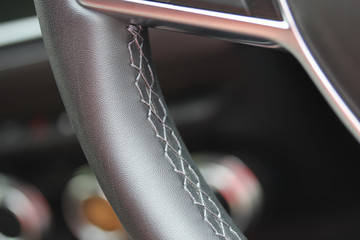 Close up of leather steering wheel stitching