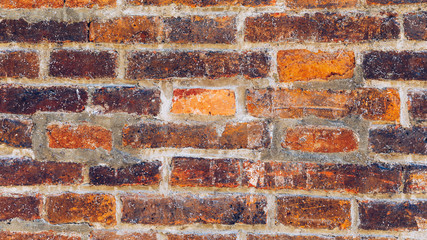 Old brick wall, old texture of red stone blocks closeup. The texture of the brick. Background of empty brick basement wall. Grunge red brick wall background with copy space.