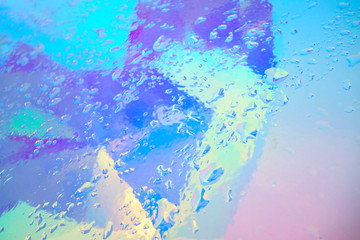 holographic plastic with water drops. abstract background