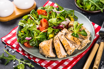 Baked chicken with fresh salad.