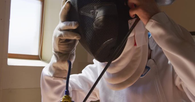 Fencer athlete during a fencing training in a gym