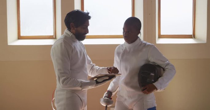 Fencer athletes during a fencing training in a gym