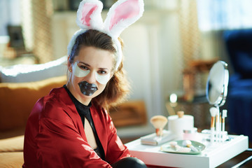 woman with bunny ears making cosmetic lip mask and eye mask