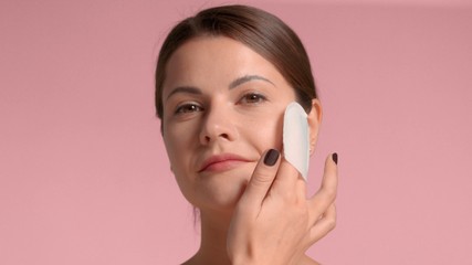 Brunette woman closeup portrait peel her face with a acid peeling pads. Gentle skin exfoliant