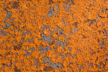 Surface of the orange rusted steel plate closeup.