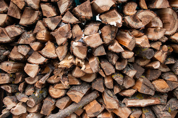 Pile of firewood. Preparation of firewood for the winter and use for cooking, firewood background, Stacks of firewood.