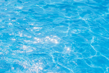 Blue and bright pool water with solar reflection, water ripple Movement and gentle wave in the pool