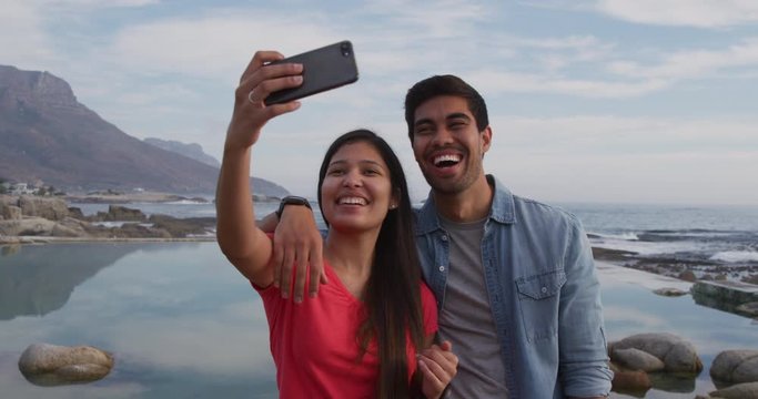 Young couple taking selfies