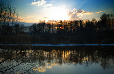 Dramatic sunset on spring river background