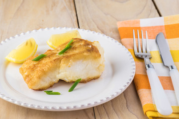 Fried light breaded cod fish.