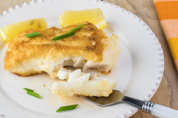 Fried light breaded cod fish.