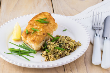 Fried light breaded cod fish.