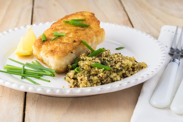 Fried light breaded cod fish.