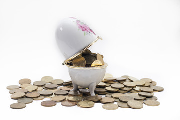 Coins on the ceramic egg
