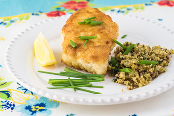 Fried light breaded cod fish.