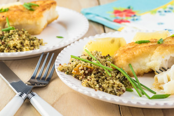 Fried light breaded cod fish.