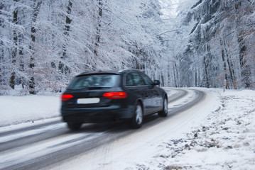 Black car in a frozen winter forest