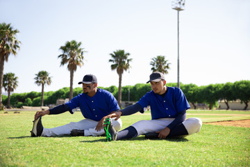 Baseball players stretching together