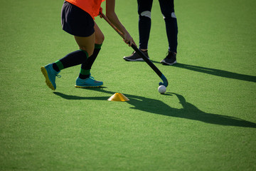 Female hockey player training on the field