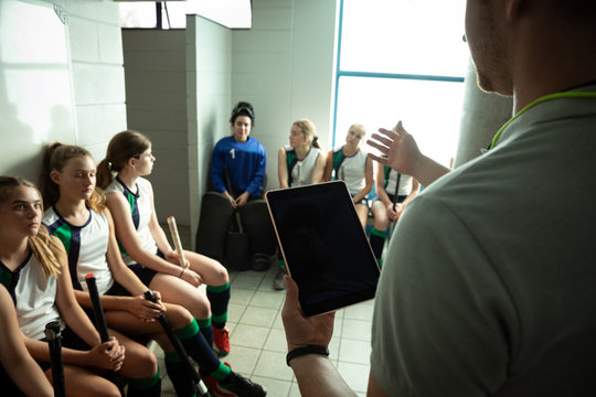 Female hockey players preparing match on a cloakroom