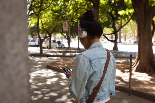 Woman listening music on the street