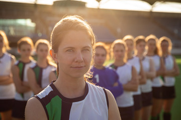 Female hockey players standing in team