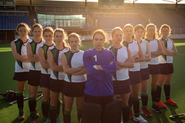 Female hockey players standing in team