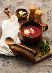 Traditional Russian borscht with bread and sour cream on the bowl. Flat lay. Top view