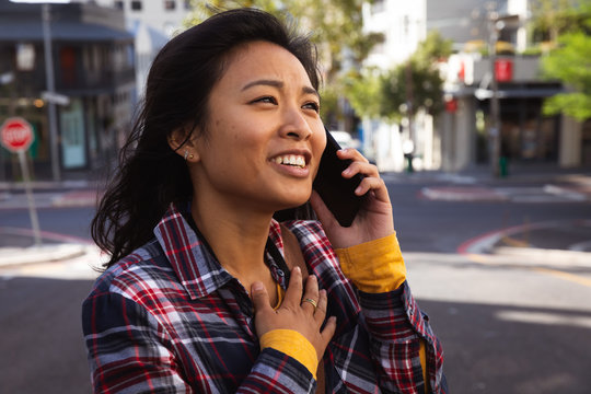Woman talking on phone on the street