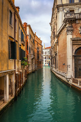 Fototapeta na wymiar View of the street canal in Venice, Italy. Colorful facades of old Venice houses. Venice is a popular tourist destination of Europe. Venice, Italy.