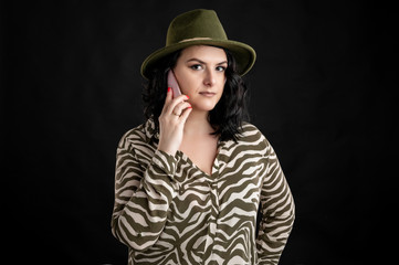 Attractive young woman dressed casually talking on cellphone, smartphone