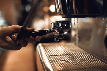 baarista working with coffee maker tools, close up side view photo