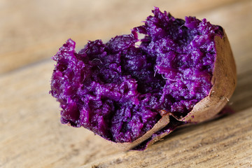 Delicious roast purple yam sweet potato on wooden table in autumn season at japan.