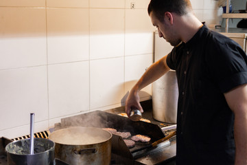 professional latin chef cooking hamburgers