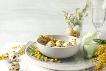 Festive Easter table setting with beautiful mimosa flowers. Space for text