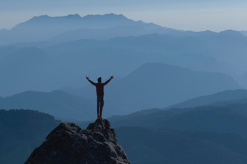 Feelings and peace of a successful climber at magnificent summits