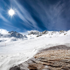 Stone top cover of snow and landscape of mountains with blue sky. 